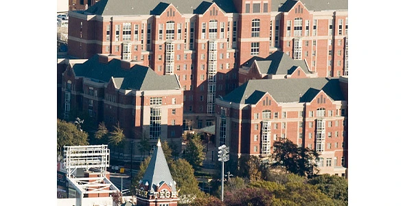 Red brick residence halls in the bright sunshine, with Georgia Tech's iconic Tech Tower in the foreground